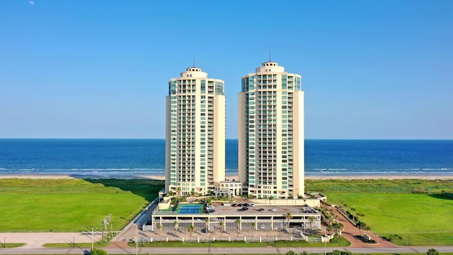 drone / aerial view featuring a water view and a view of the beach