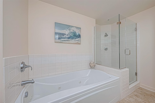 bathroom with a whirlpool tub and a shower stall