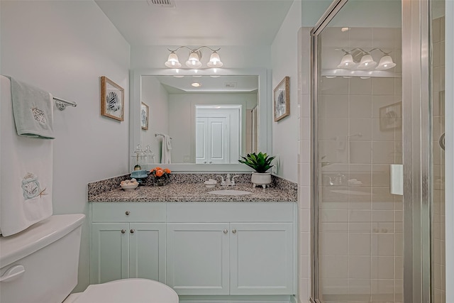 full bath with visible vents, a stall shower, vanity, and toilet