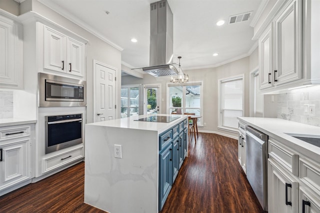 kitchen with blue cabinetry, white cabinetry, island range hood, a kitchen island, and appliances with stainless steel finishes