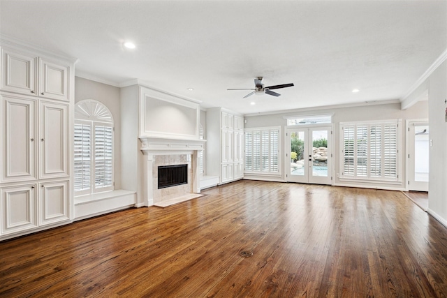 unfurnished living room with ceiling fan, wood-type flooring, crown molding, and a high end fireplace