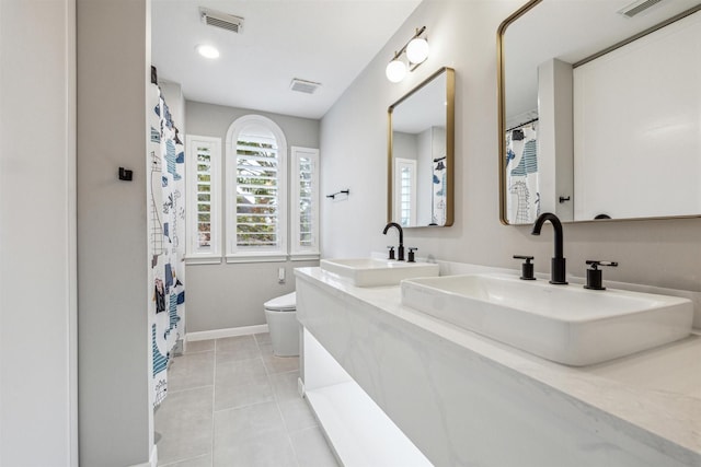 bathroom with tile patterned floors, vanity, and toilet