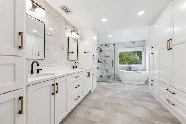 bathroom featuring vanity, tile walls, and plus walk in shower