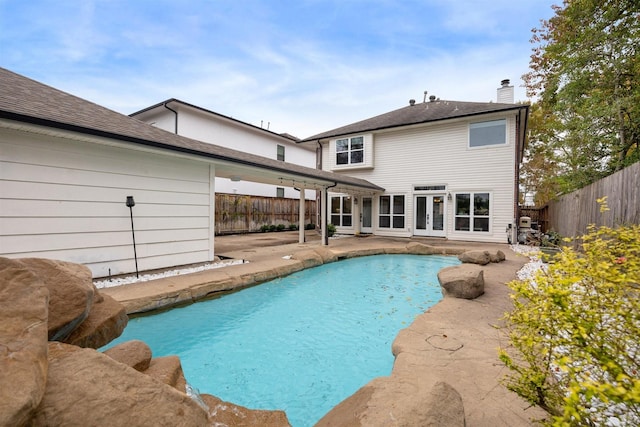 view of swimming pool featuring french doors