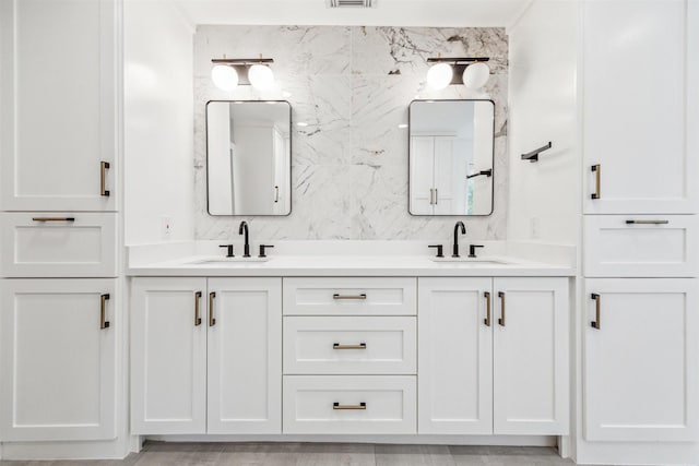 bathroom with vanity and tile walls