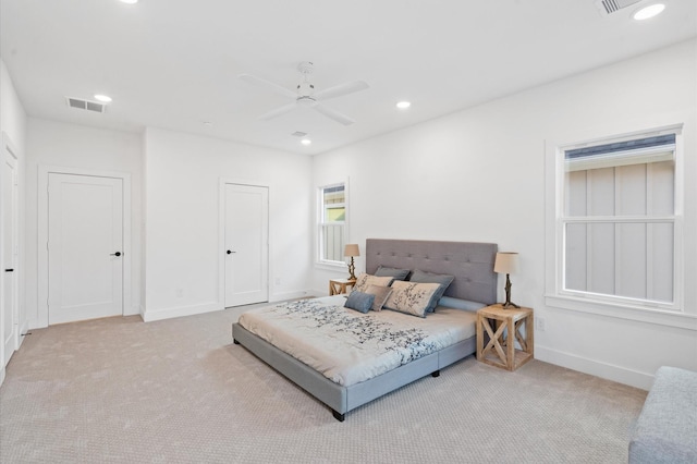 bedroom with ceiling fan and light colored carpet