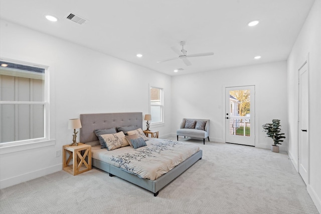 carpeted bedroom featuring multiple windows, access to outside, and ceiling fan