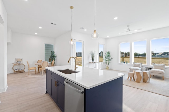 kitchen with ceiling fan, sink, light hardwood / wood-style flooring, stainless steel dishwasher, and pendant lighting