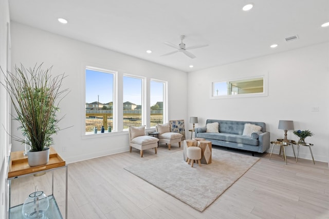 living room featuring ceiling fan and light hardwood / wood-style floors