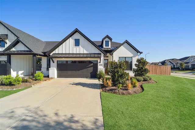 modern farmhouse featuring a garage and a front yard