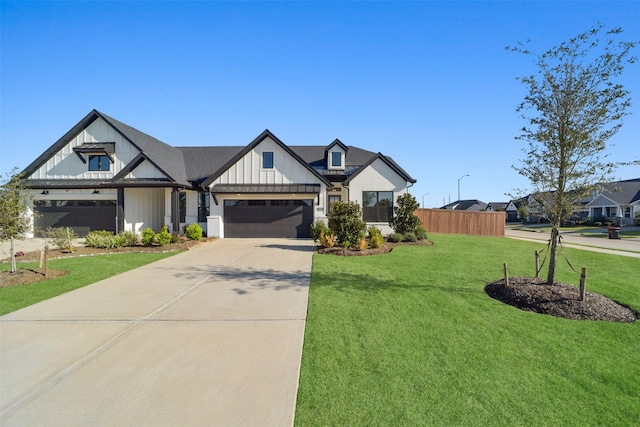 modern farmhouse style home featuring a front yard and a garage