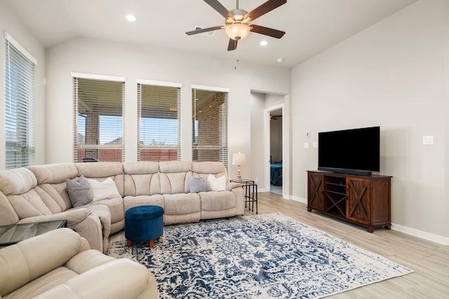 living room featuring ceiling fan, light hardwood / wood-style flooring, and lofted ceiling