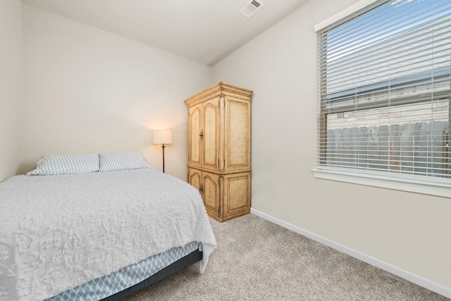 carpeted bedroom with vaulted ceiling