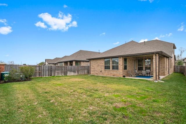 back of property featuring a lawn and a patio area