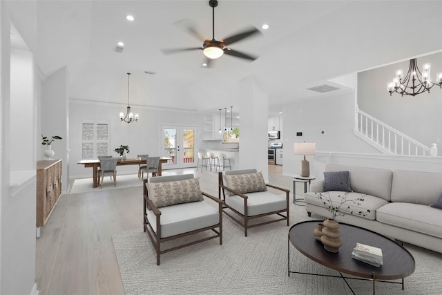 living room featuring ceiling fan, french doors, light hardwood / wood-style floors, and lofted ceiling