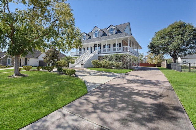 view of front of property with a porch and a front lawn