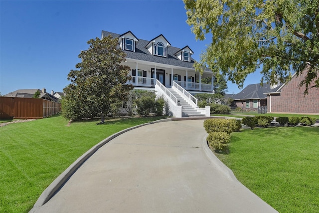 new england style home featuring a front lawn and a porch