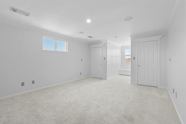 carpeted spare room featuring crown molding and a healthy amount of sunlight