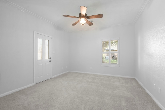 carpeted empty room featuring ceiling fan and ornamental molding