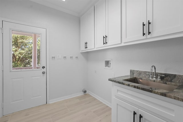 washroom featuring washer hookup, cabinets, and sink