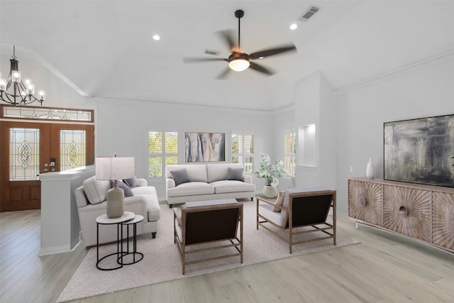 living room featuring french doors, crown molding, light hardwood / wood-style flooring, and lofted ceiling