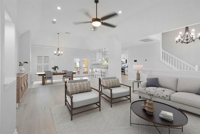 living room featuring ceiling fan, french doors, light hardwood / wood-style flooring, and vaulted ceiling