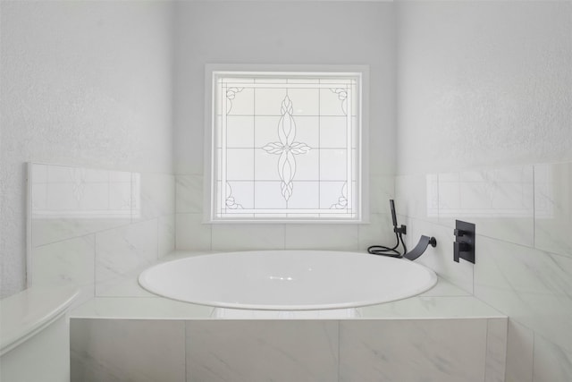 bathroom with tiled bath