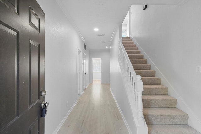 interior space featuring light hardwood / wood-style floors and ornamental molding