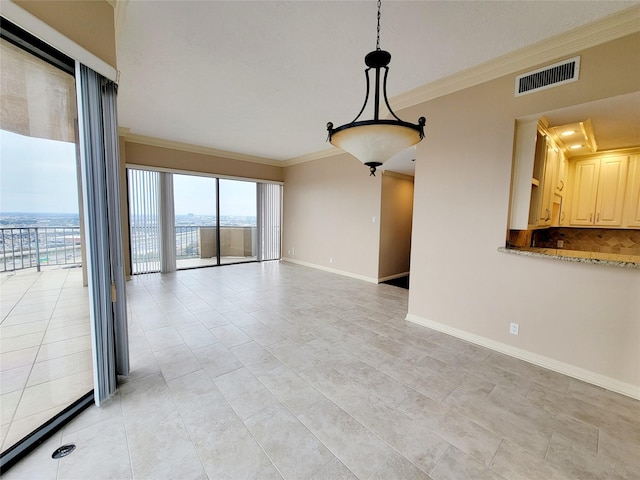 empty room featuring ornamental molding and light tile patterned floors