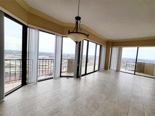 unfurnished room with light tile patterned floors, a textured ceiling, and ornamental molding