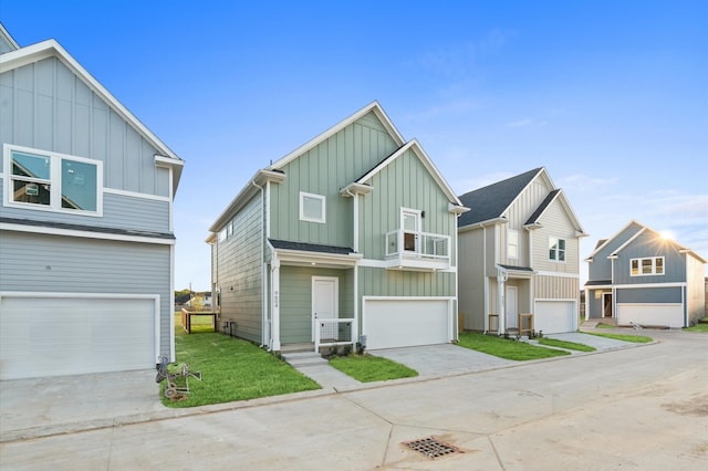 view of front of property featuring a garage, a balcony, and a front lawn