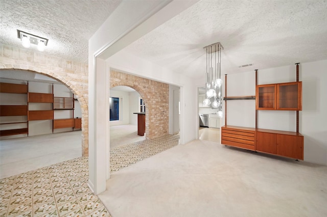 unfurnished room with a textured ceiling