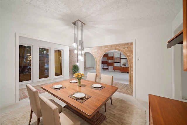 dining space with a textured ceiling