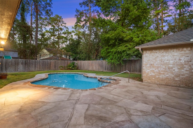 pool at dusk with a patio