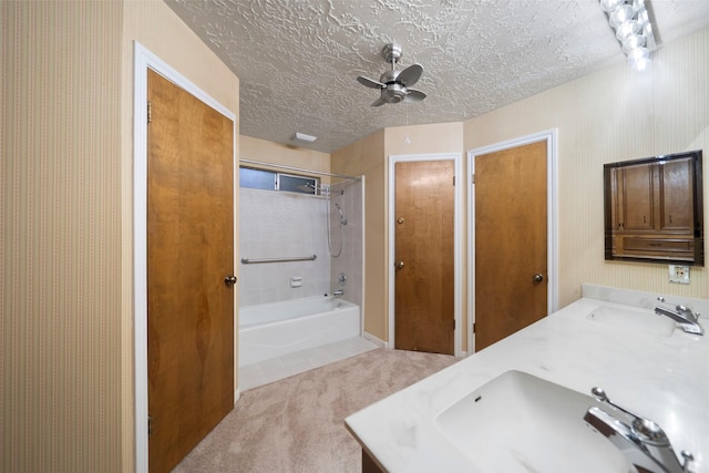 bathroom featuring washtub / shower combination, a textured ceiling, vanity, and ceiling fan