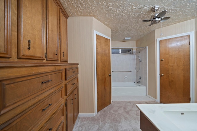 bathroom featuring a textured ceiling, vanity, ceiling fan, and  shower combination