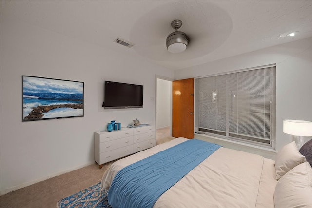 bedroom with ceiling fan and light carpet