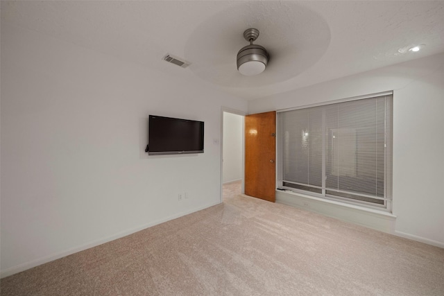 spare room featuring carpet flooring and ceiling fan