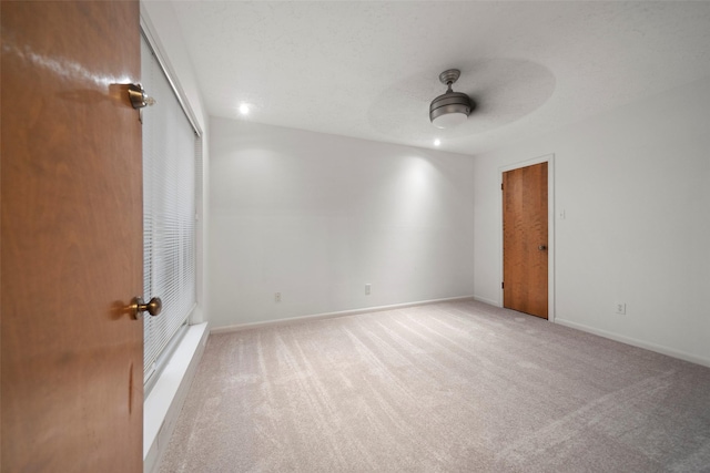 unfurnished room featuring ceiling fan and light colored carpet