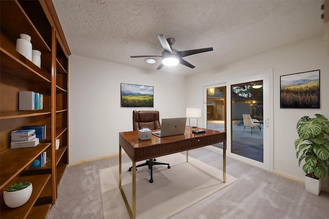 carpeted office with a textured ceiling and ceiling fan