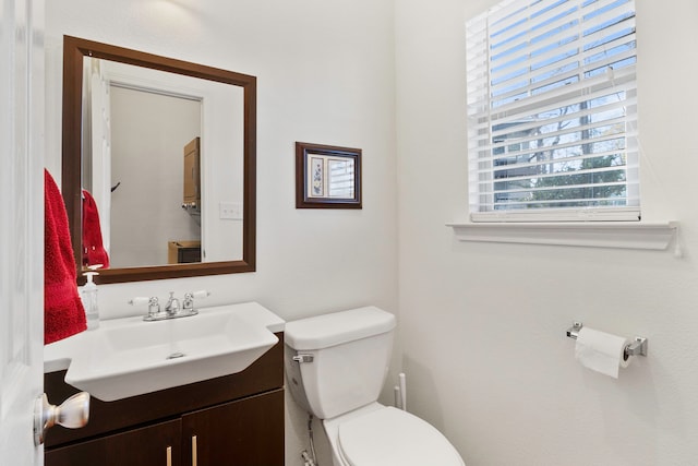 bathroom featuring toilet and vanity