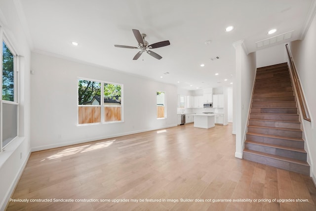 unfurnished living room with ceiling fan, light hardwood / wood-style floors, and ornamental molding