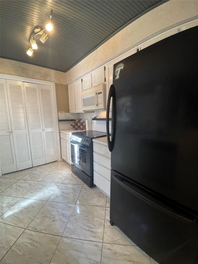 kitchen with white cabinetry and black appliances