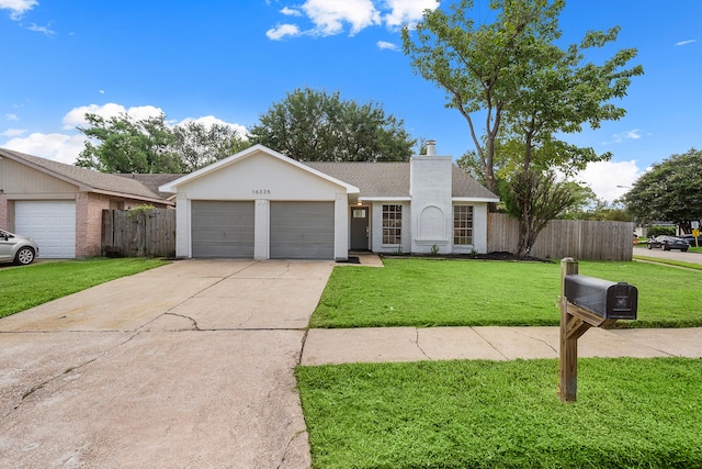 single story home with a garage and a front lawn