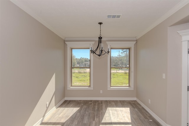 unfurnished dining area featuring a notable chandelier and ornamental molding