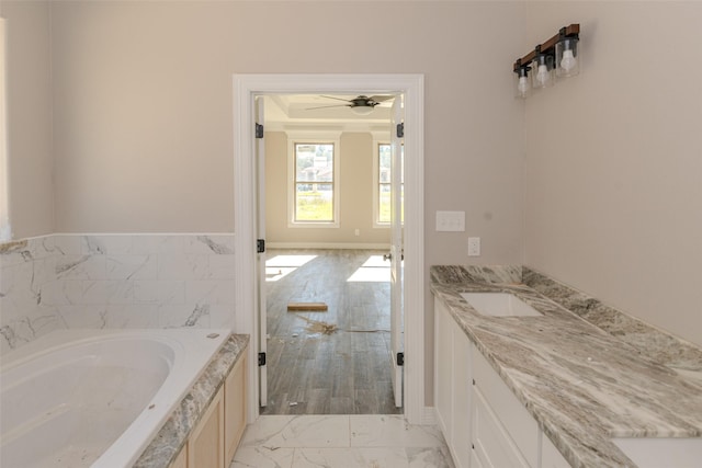 bathroom featuring vanity, a bathtub, and ceiling fan