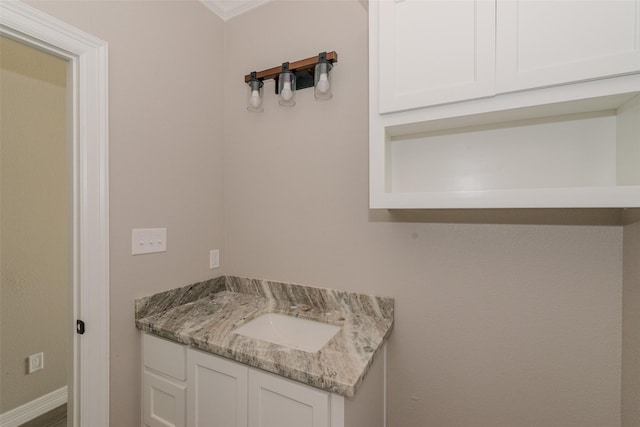 bathroom featuring vanity and ornamental molding