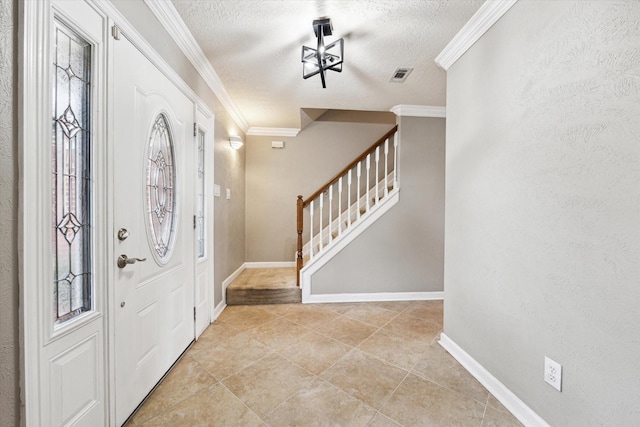 entrance foyer with crown molding and a textured ceiling