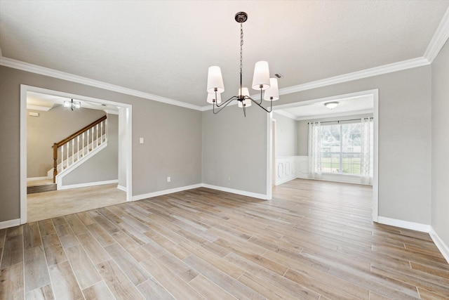 interior space with an inviting chandelier, crown molding, and light hardwood / wood-style flooring