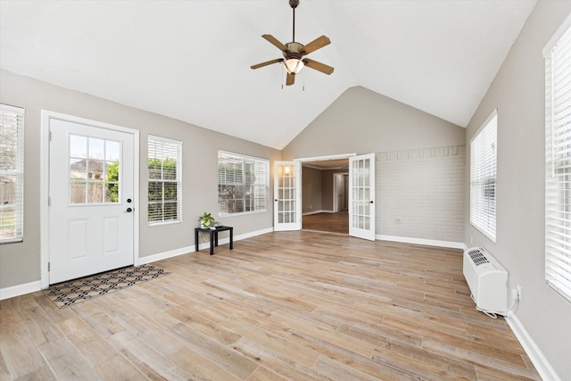 entryway featuring lofted ceiling, light hardwood / wood-style floors, an AC wall unit, and ceiling fan